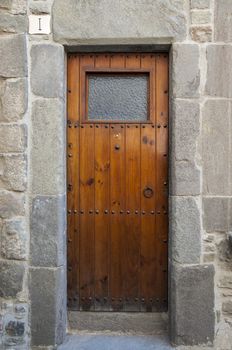 old wooden door with stone wall