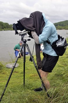 Cardet - France - May 18th, 19th and 20th, 2013 - European Cup of the gold diggers in river. photographer in nature with photographic equipment large size of studio