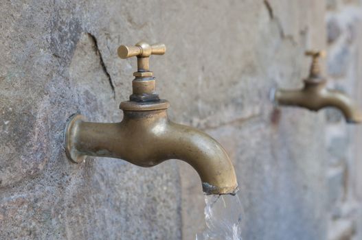 golden faucet with running water