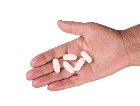 Tablets L-arginine in the hand of an old man on a white background