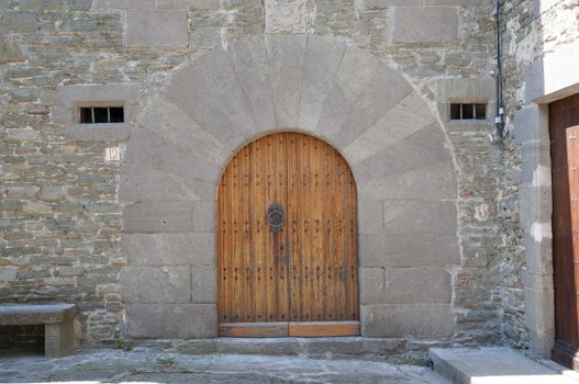 old wooden door with stone wall