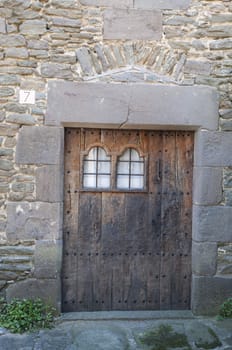 old wooden door with stone wall