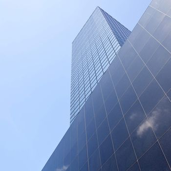 cloud and blue sky reflected in office building in Rotterdam