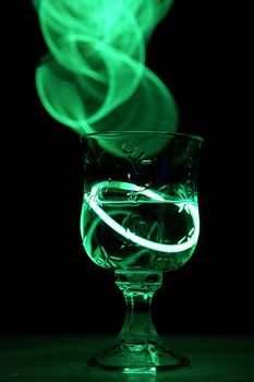 A neat party drink with an aurora glow stick.