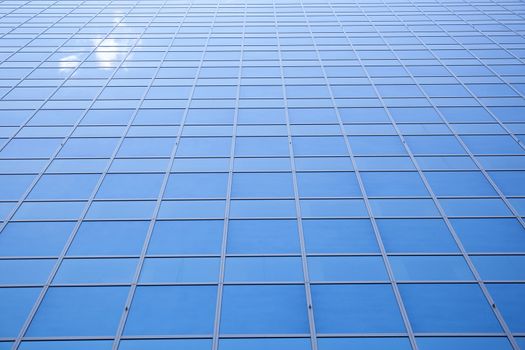 blue sky and one cloud reflected in facade of office building in Rotterdam