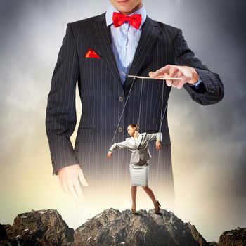 Image of young businessman puppeteer. Leadership concept