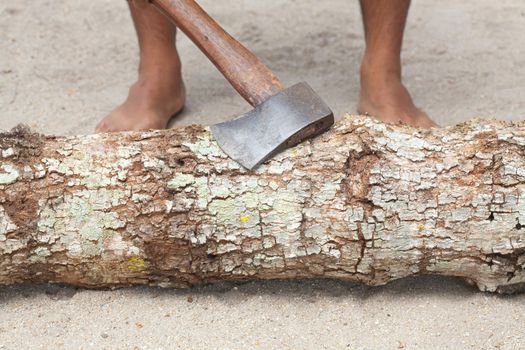 Man splitting wood with an ax
