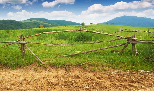 Old broken wooden fence in the mountains