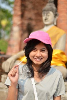 Beautiful young girl and buddha at Wat Yai Chai Mongkol Temple. Ayutthaya - Thailand 