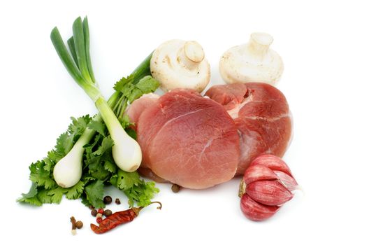 Perfect Piece of Boneless Raw Pork with Greens, Spring Onion, Spices and Edible Mushrooms isolated on white background