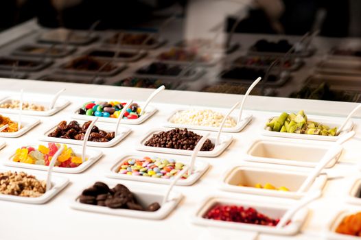 Variety of colorful toppings and yummy jellies displayed