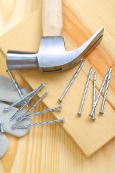 composition of hammer and nails with glove closeup