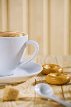 composition of the white coffee cup with spoon and bread tor, bar of sugar