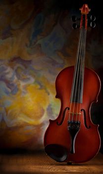 old violin on wooden board