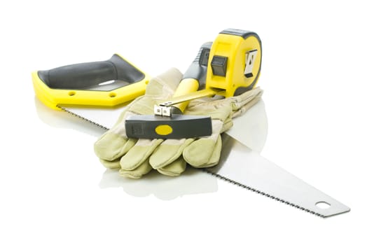 saw gloves tapeline and hammer