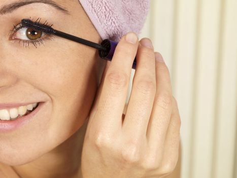 Young Woman Applying Mascara. Model Released