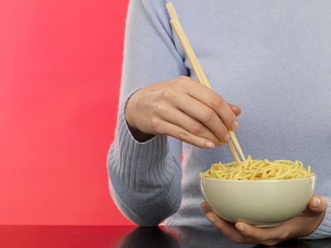 Young Woman Eating Noodles