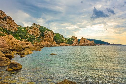bay with clear turquoise water on a cloudy day on the island sardinia