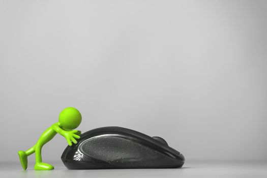 Green man pushing a computer mouse. Gray background