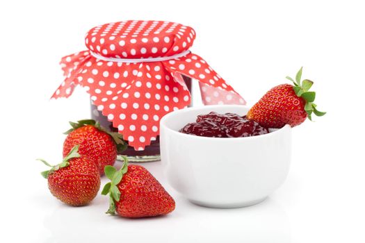 Strawberry berries and a jar of jam isolated on white background