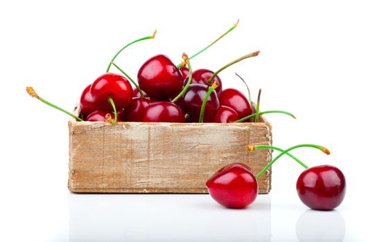 cherry berry in wooden bowl, isolated on white background