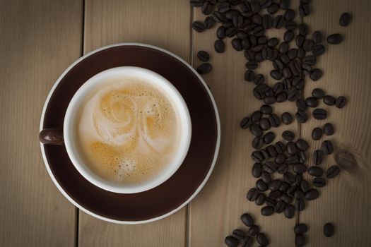 cup of coffee on wooden background