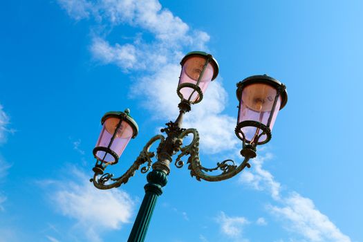 old street-lamp on blue sky