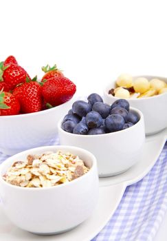 fresh blueberry, strawberry corn flakes in porcelain bowl