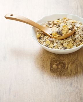 bowl with muesli on wooden background