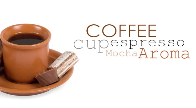 Closeup shot of freshly prepared cup of italian espresso with cinnamon and candy over white background