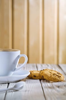 coffee cup and cookies on old white table