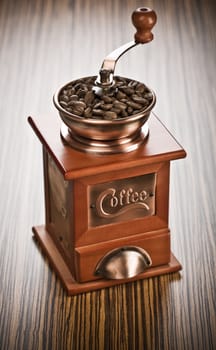 coffee mill on wooden background