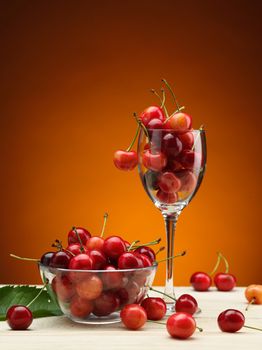 tasty fresh and ripe red cherry in the glass on wooden table
