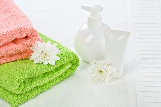 Accessories for bathing with flower on towel
