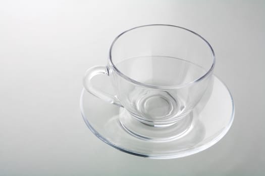 cup on plate isolated on gray
