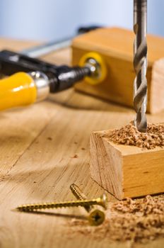 Drilling hole in a wooden plank.