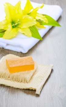 flower on towel and soap on bast