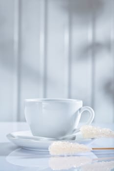 coffee cup and other items on white table