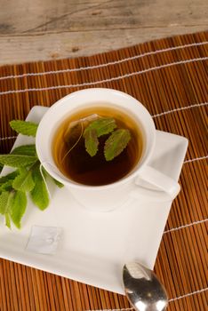 Freshly made tea scented with spearmint leaves