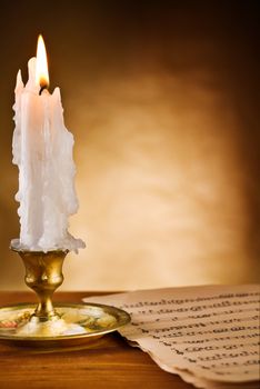 copy space view on the ablaze candle and old notes