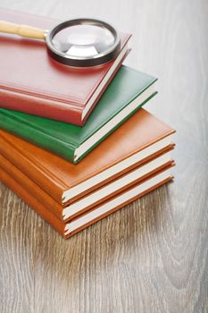 five notebooks and magnifier