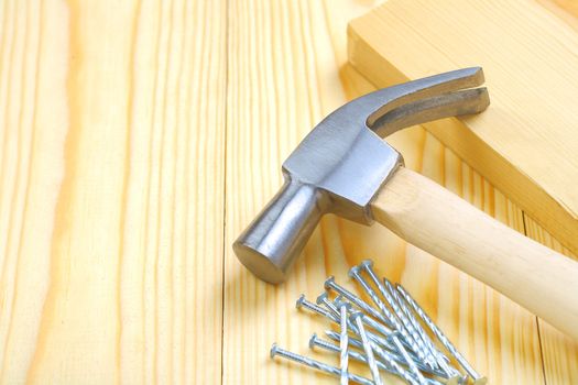 hammer with nails and plank
