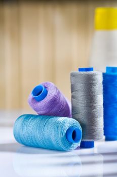 copmosition of sewing spools on white table