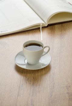 diary with cup of coffee