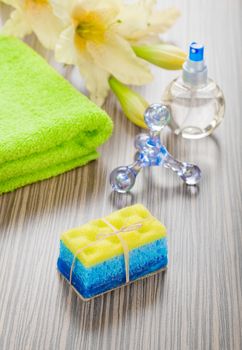 bath objects and flower on wooden background