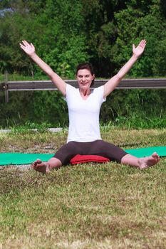 Mature woman doing yoga outdoors