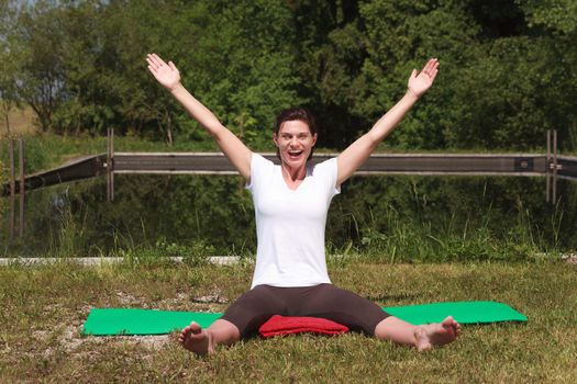 Mature woman doing yoga outdoors