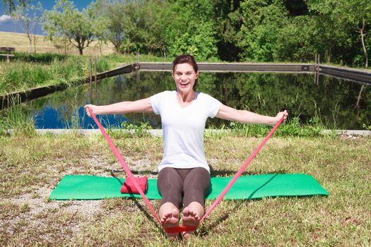 Mature woman doing yoga outdoors