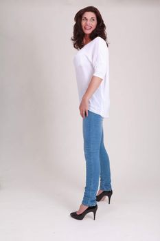 laughing senior model in fashionable jeans with a white blouse