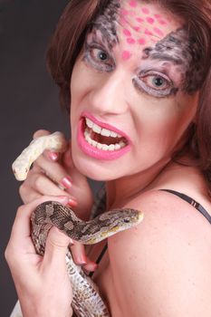 Portrait of a woman with two snakes in hand
